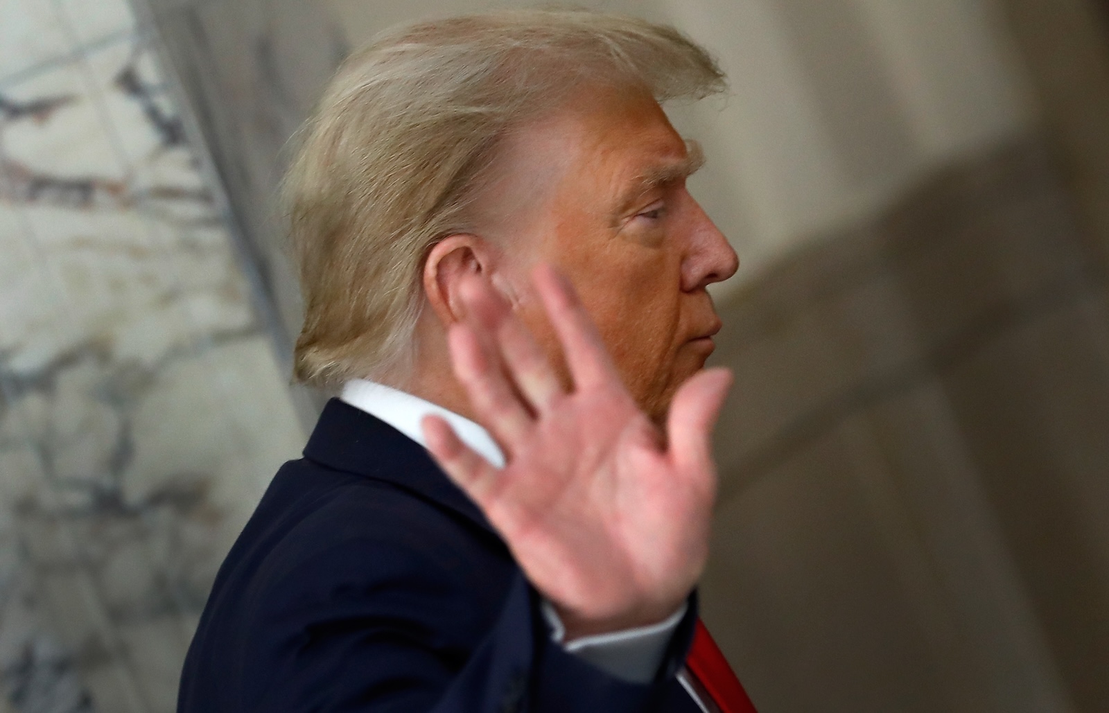 epa10998594 Former US President Donald J. Trump gestures to the media during a short recess on the third day of his civil fraud trial in New York, New York, USA, 04 October 2023.  EPA/PETER FOLEY