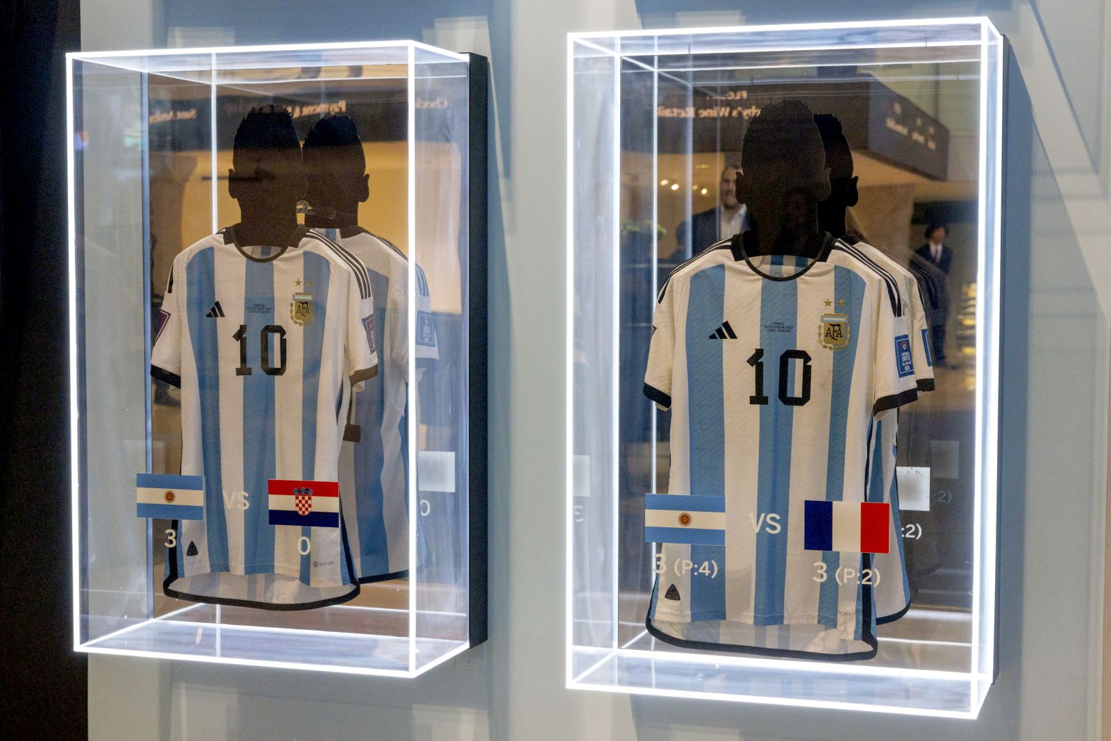 epa11003465 Two of the six match-worn shirts of Argentine soccer player Lionel Messi from the 2022 FIFA World Cup are on display before auction at Sotheby's in New York, New York, USA, 30 November 2023. The set of six shirts will be offered in a dedicated sale open for bidding from 30 November to 14 December.  EPA/SARAH YENESEL