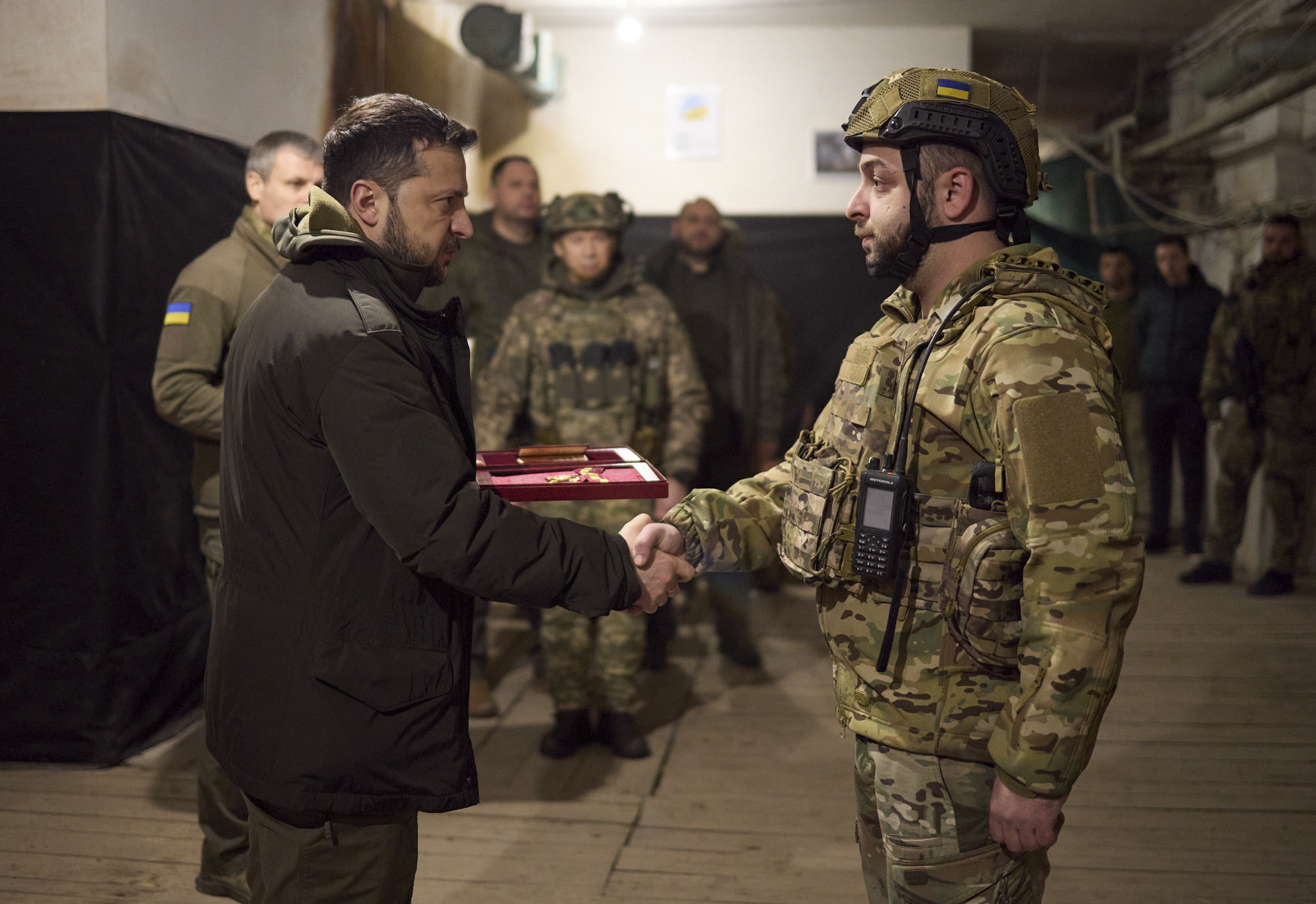epa11003553 A handout photo made available by the presidential press service shows Ukrainian President Volodymyr Zelensky (L) handing an award to a serviceman at the headquarters of the Defense Forces near a frontline close to Kupiansk during his working trip to Kharkiv region, Ukraine, 30 November 2023 amid the Russian invasion. Volodymyr Zelenskyy and Defense Minister Rustem Umerov listened to a report on the operational situation in that area and hand State awards to Ukrainian servicemen.  EPA/PRESIDENTIAL PRESS SERVICE HANDOUT HANDOUT 36225 HANDOUT EDITORIAL USE ONLY/NO SALES HANDOUT EDITORIAL USE ONLY/NO SALES