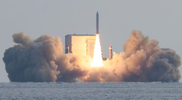 epa11010200 South Korea's third launch of a solid-fuel space rocket from a barge floating in waters takes place about 4 kilometers south of Jeju Island, South Korea, 04 December 2023, successfully placing a small Earth observation satellite into orbit at an altitude of about 650 km. The 100-kilogram synthetic aperture radar (SAR) satellite was made by Hanwha Systems.  EPA/YONHAP SOUTH KOREA OUT