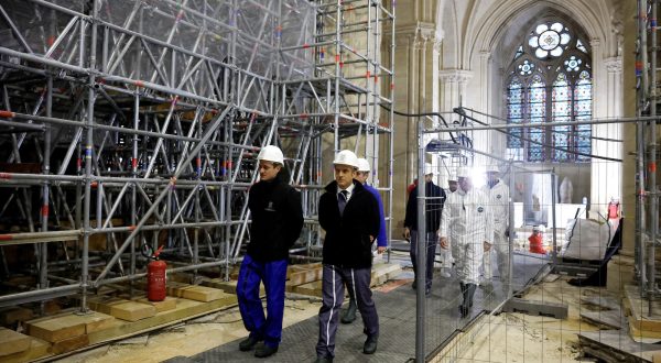 epa11017102 French President Emmanuel Macron (R front), wearing a working helmet, arrives to visit the nave of the Notre-Dame de Paris Cathedral, in Paris, France, 08 December 2023. French President Emmanuel Macron is visiting Notre Dame Cathedral on 08 December, to mark the one-year countdown to its reopening in 2024 following extensive restoration after the fire four years ago. Macron's visit, continuing his annual tradition since the blaze on 15 April 2019, is aimed to highlight the progress in the works, including the near completion of the cathedral spire.  EPA/SARAH MEYSSONNIER / POOL  MAXPPP OUT