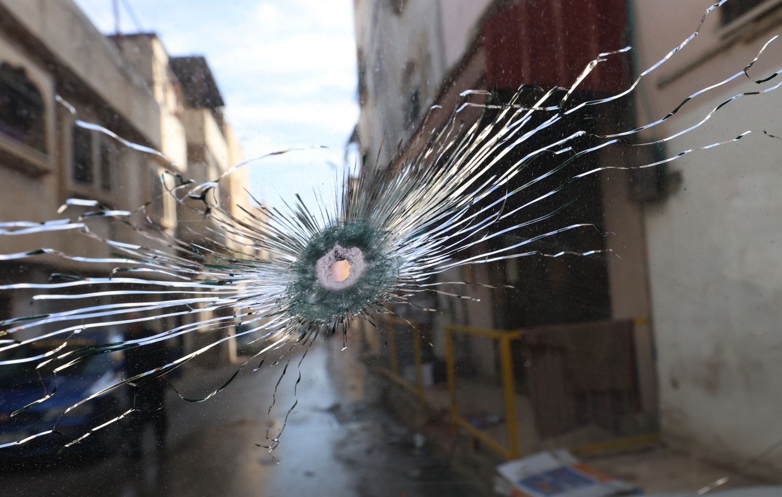 epa11017169 A bullet hole in the windscreen of a car following an Israeli military raid at Al Farea refugee camp near the West Bank city of Tubas, 08 December 2023. According to the Palestinian Health Ministry, six Palestinians were killed and 12 others were injured during clashes that erupted after Israeli troops raided their camp.  EPA/ALAA BADARNEH