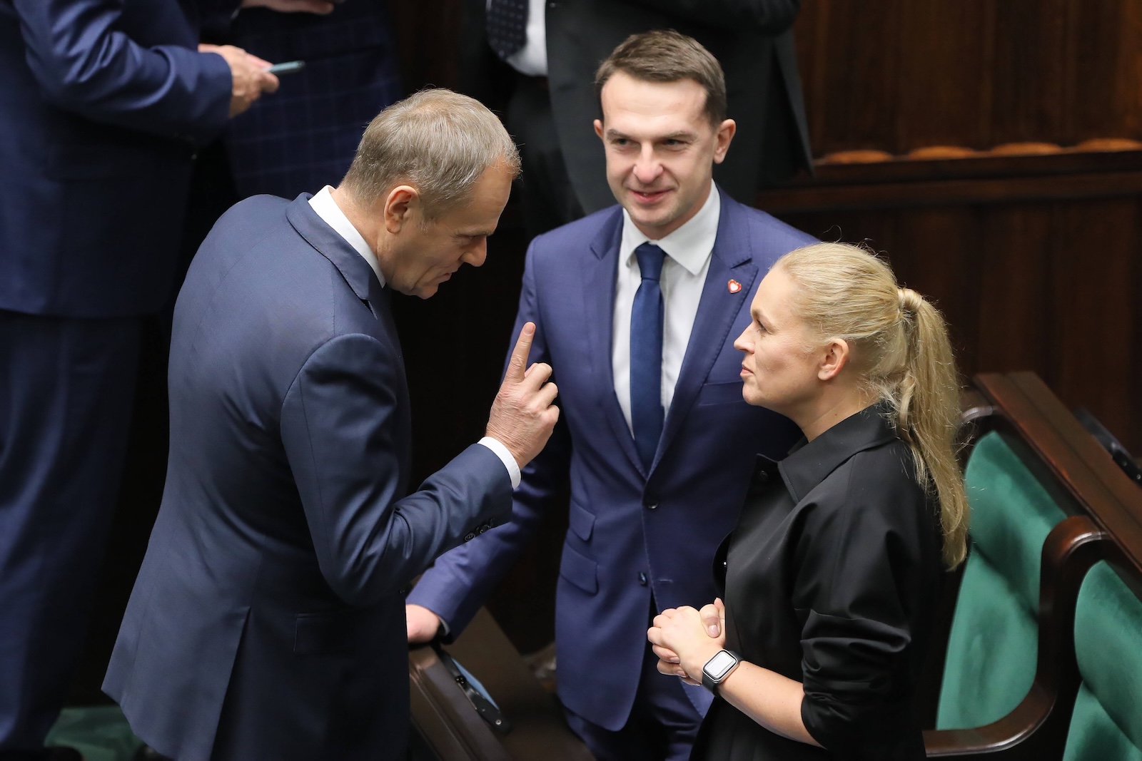 epa11022676 Civic Platform party (PO) leader Donald Tusk (L) talks to deputies Adam Szlapka (C) and Barbara Nowacka (R) at the Sejm hall, the lower house of the Polish parliament, in Warsaw, Poland, 11 December 2023. Prime Minister Morawiecki on 11 December will present the agenda of the Council of Ministers with a motion for a vote of confidence. According to the Sejm website, the vote of confidence in Mateusz Morawiecki's government will be followed by a one and a half hour break, during which candidacies for the so-called Prime Minister will be submitted. A candidate for prime minister can be proposed by a group of at least 46 MPs.  EPA/PAWEL SUPERNAK POLAND OUT