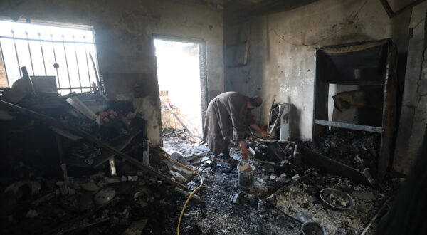 epa11026176 Palestinians inspect damage at a burned house as Israeli forces conduct a raid for a second day at Jenin refugee camp near the West Bank city of Jenin, 13 December 2023. According to the Palestinian Health ministry, seven Palestinians were killed in Jenin during an Israeli military raid on 12 December. Thousands of Israelis and Palestinians have died since the militant group Hamas launched an unprecedented attack on Israel from the Gaza Strip on 07 October, and the Israeli operations in Gaza and the West Bank which followed it.  EPA/ALAA BADARNEH
