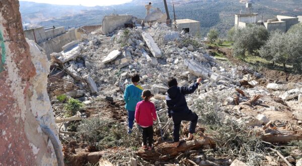 epa11031271 Palestinian children inspect the rubble of the home of the family of Hamed Sabbah in Urif village, south of the West Bank city of Nablus, 15 December 2023. The Israeli army demolished the houses of Ziad Jibril Al-Safadi and Hamed Sabbah, two alleged gunmen named responsible for a shooting attack near the West Bank settlement of Eli in June that killed four Israelis.  EPA/ALAA BADARNEH