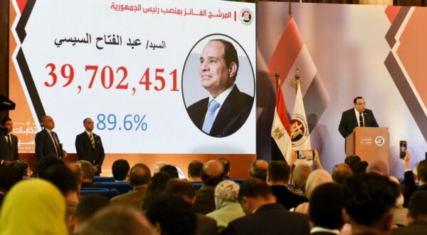 epaselect epa11035920 Head of Egypt's National Election Authority Hazem Badawy (R) speaks next to a display showing the number of votes for President Abdel Fattah al-Sisi during a press conference to announce the results of the presidential elections, in Cairo, Egypt, 18 December 2023. Egypt's President Abdel Fattah al-Sisi won a new six-year term with 89.6 percent of the votes in the presidential elections held between 10 and 12 December, the election authority announced. The elections witnessed a turnout of 66.8 percent, with 44.7 million citizens voting in the elections at home and abroad, out of nearly 67 million eligible voters, according to the figures released by the authority.  EPA/TAREK WAJEH
