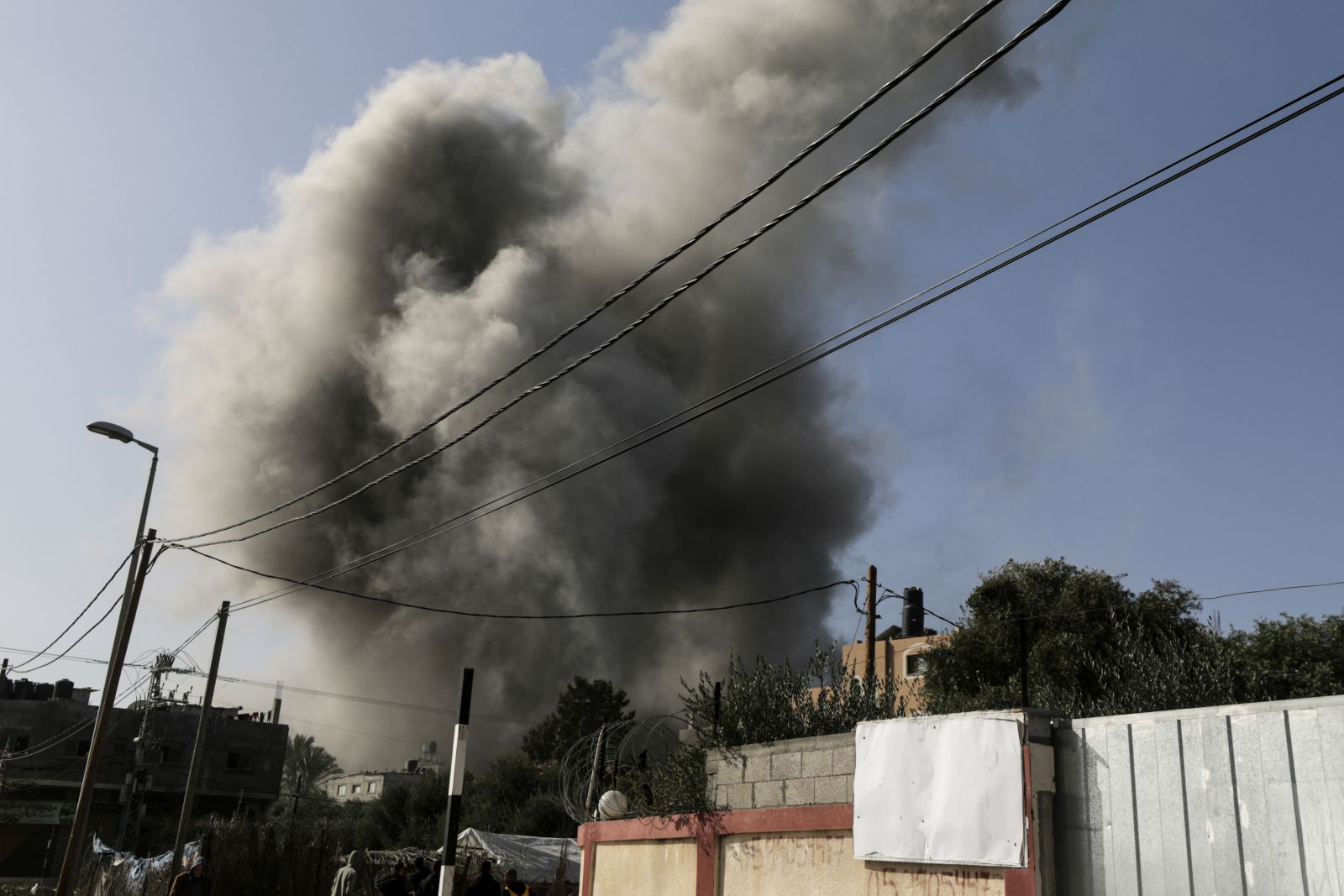 epa11041066 Smoke billows above buildings following an Israeli air strike at the Al-Nuseirat refugee camp, along the Salah al-Din road, in central Gaza Strip, 22 December 2023. More than 19,600 Palestinians and at least 1,300 Israelis have been killed, according to the Palestinian Health Ministry and the Israel Defense Forces (IDF), since Hamas militants launched an attack against Israel from the Gaza Strip on 07 October, and the Israeli operations in Gaza and the West Bank which followed it.  EPA/MOHAMMED SABER