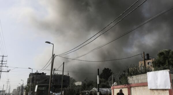 epa11041067 Smoke rises over a street following an Israeli air strike at the Al-Nuseirat refugee camp, along the Salah al-Din road, in central Gaza Strip, 22 December 2023. More than 19,600 Palestinians and at least 1,300 Israelis have been killed, according to the Palestinian Health Ministry and the Israel Defense Forces (IDF), since Hamas militants launched an attack against Israel from the Gaza Strip on 07 October, and the Israeli operations in Gaza and the West Bank which followed it.  EPA/MOHAMMED SABER