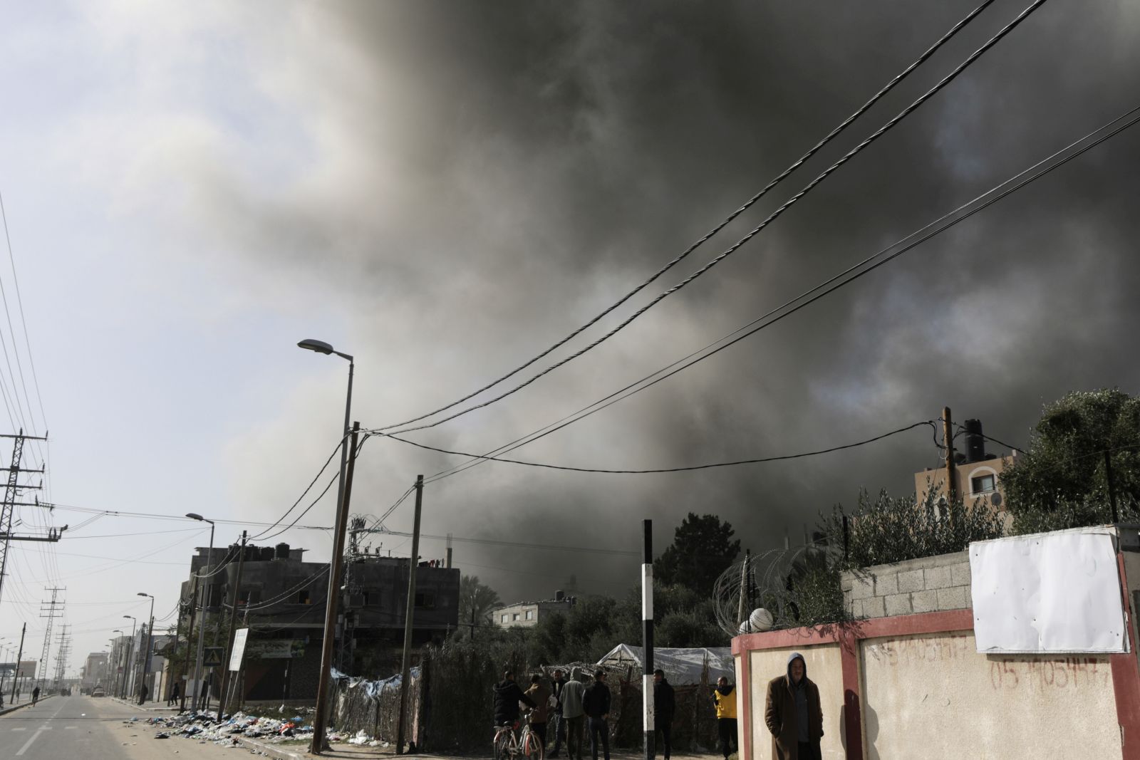 epa11041067 Smoke rises over a street following an Israeli air strike at the Al-Nuseirat refugee camp, along the Salah al-Din road, in central Gaza Strip, 22 December 2023. More than 19,600 Palestinians and at least 1,300 Israelis have been killed, according to the Palestinian Health Ministry and the Israel Defense Forces (IDF), since Hamas militants launched an attack against Israel from the Gaza Strip on 07 October, and the Israeli operations in Gaza and the West Bank which followed it.  EPA/MOHAMMED SABER