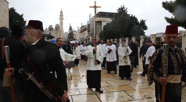 epa11042952 Catholic clergy walk in procession at Manger Square, leading to the Church of the Nativity,  in the West Bank town of Bethlehem, 24 December 2023. Church leaders in the historical Christian town of Bethlehem, traditionally revered as the birthplace of Jesus, have announced the cancelation of public Christmas celebrations this year in solidarity with the people of Gaza amid the ongoing Israel-Gaza conflict. Christmas activities will be limited to worship and prayer, without the usual Christmas lights and tree.  EPA/Wisam Hashlamoun