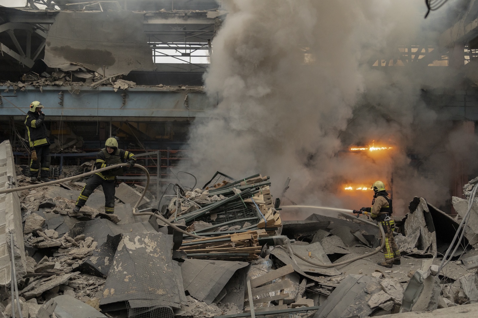 epa11047934 Ukrainian rescuers work at the site of a rocket attack on a civilian factory in Kharkiv, northeastern Ukraine, 29 December 2023, amid the Russian invasion. At least 16 people have died and dozens more injured after Russia launched a wave of airstrikes across Ukraine, Ukrainian authorities said on 29 December. Strikes were reported in Kyiv, Lviv, Odesa, Dnipro, Kharkiv, Zaporizhzhia, and other Ukrainian cities. Russia launched 'more than 150 missiles and combat drones' at Ukrainian cities, Ukraine's Prosecutor General Andriy Kostin said in a statement, adding that extensive damage included residential buildings, educational institutions and hospitals. Russian troops entered Ukraine on 24 February 2022 starting a conflict that has provoked destruction and a humanitarian crisis.  EPA/YAKIV LIASHENKO