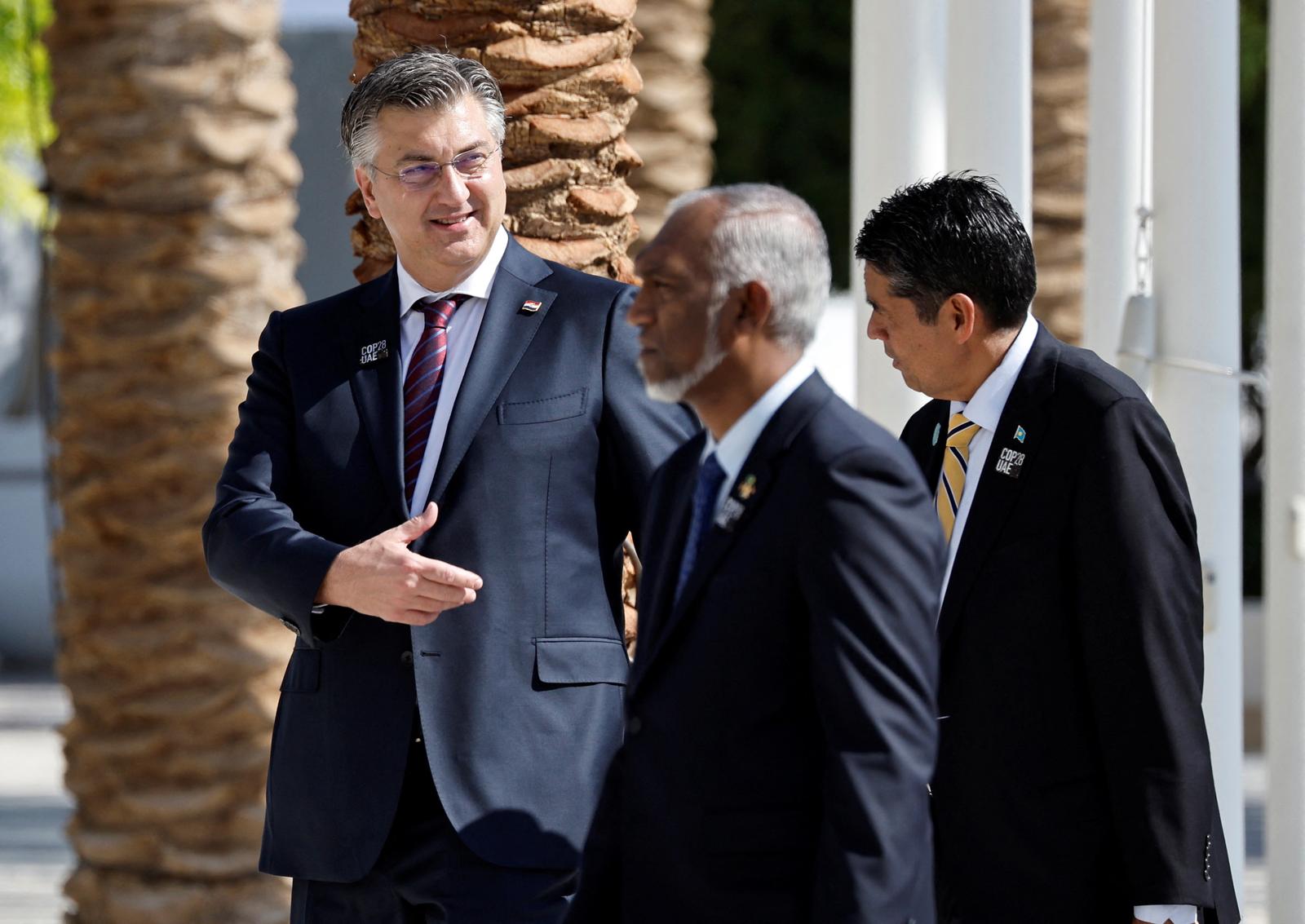 Croatian Prime Minister Andrej Plenkovic and Palau's President Surangel Whipps Jr. walk to pose for a family photo during the United Nations Climate Change Conference (COP28) in Dubai, United Arab Emirates, December 1, 2023. REUTERS/Thaier Al-Sudani Photo: THAIER AL-SUDANI/REUTERS