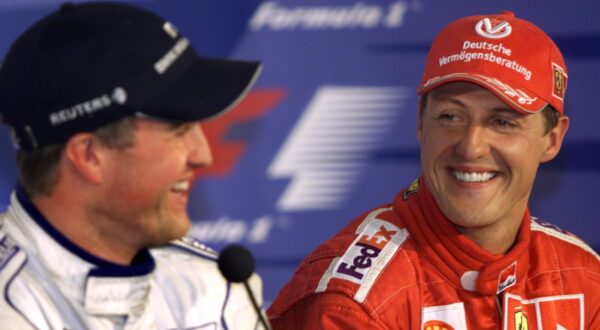 Ferrari's Michael Schumacher, right, of Germany, shares a laugh with his brother Ralf during a news conference following the qualifying session at the Canadian Grand Prix Saturday June 9, 2001, in Montreal. Micheal took the pole position while Ralf will start second for the Sunday race. (AP Photo/Kevin Frayer)