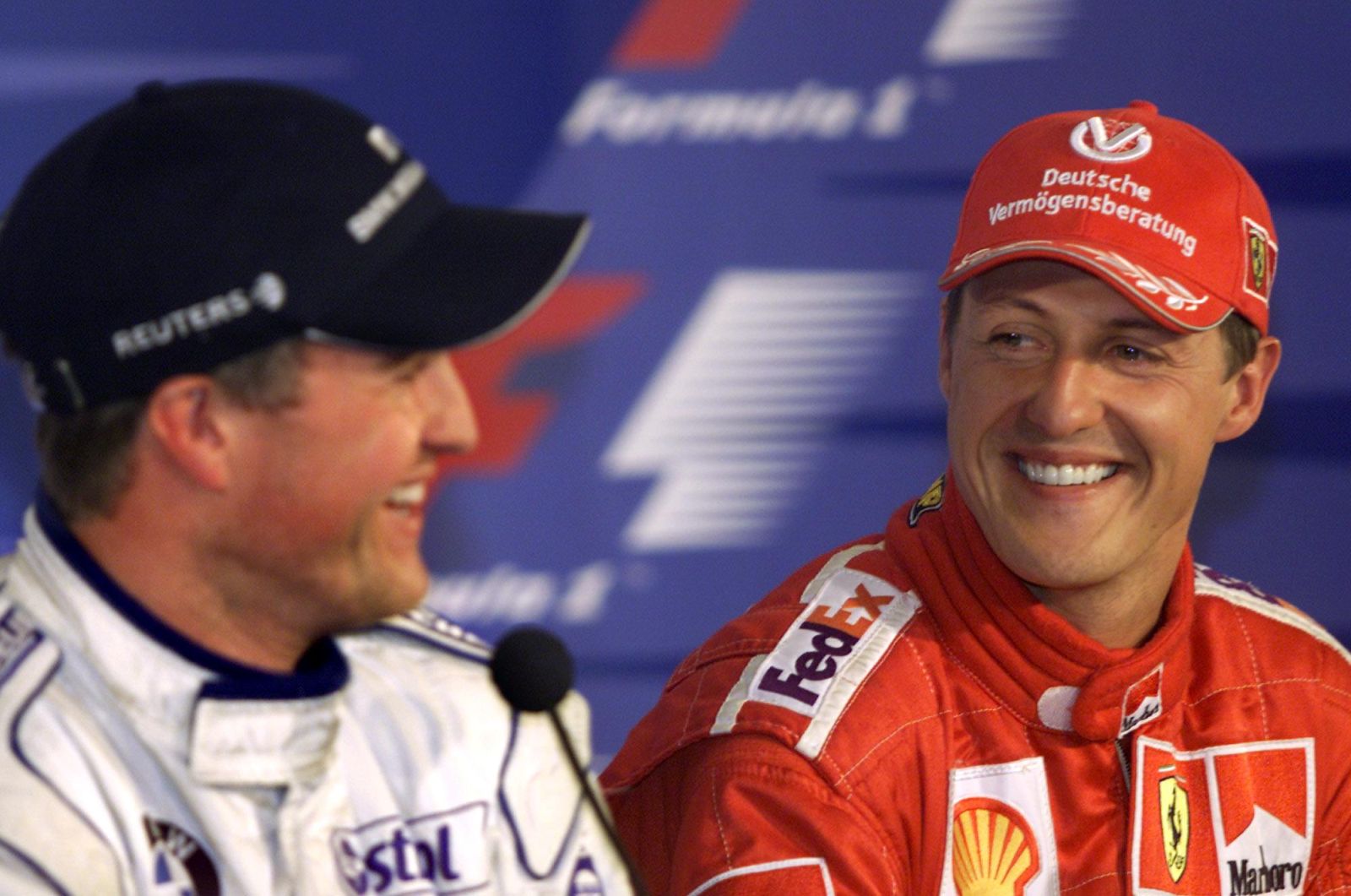 Ferrari's Michael Schumacher, right, of Germany, shares a laugh with his brother Ralf during a news conference following the qualifying session at the Canadian Grand Prix Saturday June 9, 2001, in Montreal. Micheal took the pole position while Ralf will start second for the Sunday race. (AP Photo/Kevin Frayer)