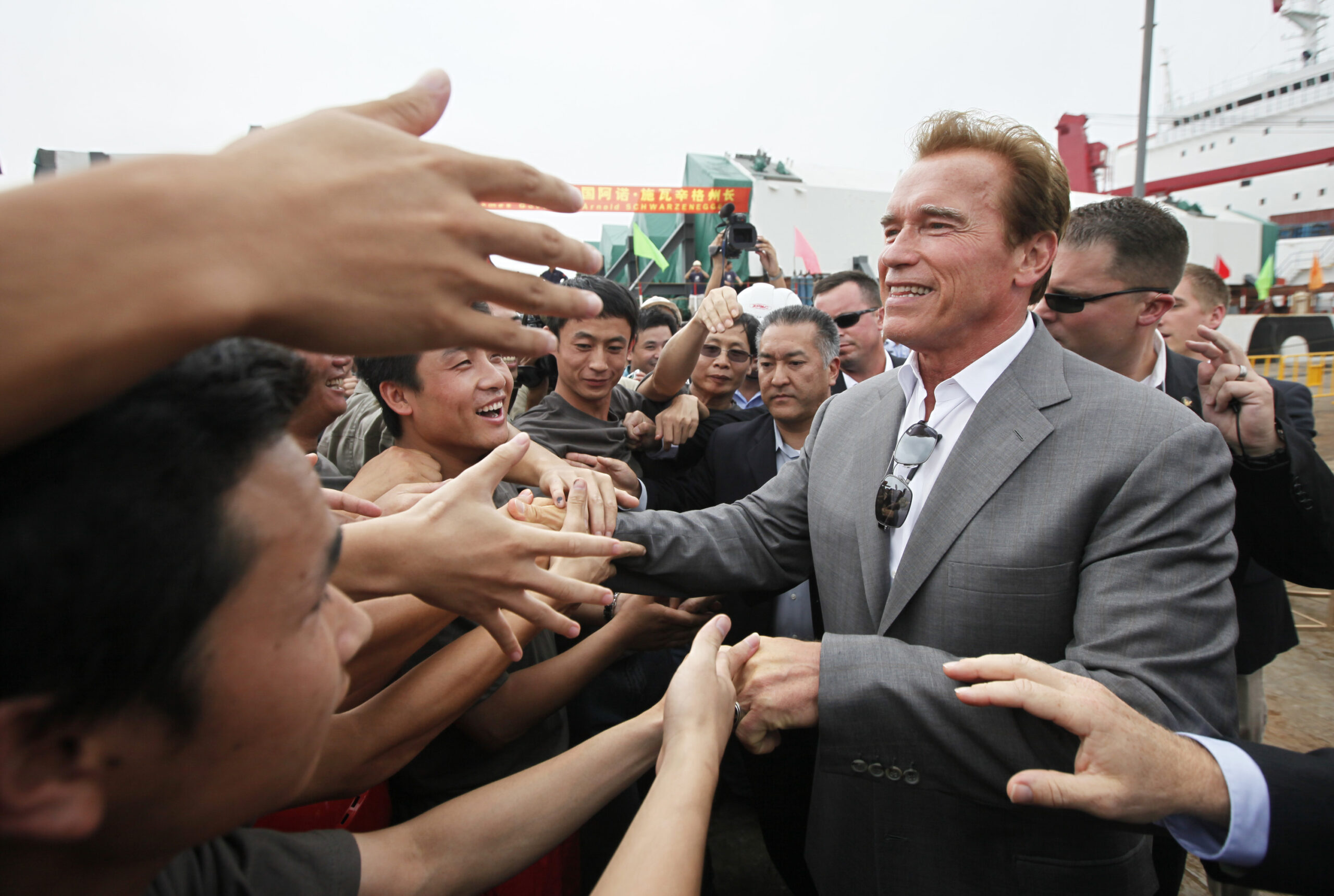 Gov. Arnold Schwarzenegger greets workers during his visit to Zhenhua Port Machinery Company (ZPMC) Monday, Sept. 13, 2010 in Shanghai. ZPMC is building the new east span of San Franciscos Oakland Bay Bridge. (AP Photo/Eugene Hoshiko)