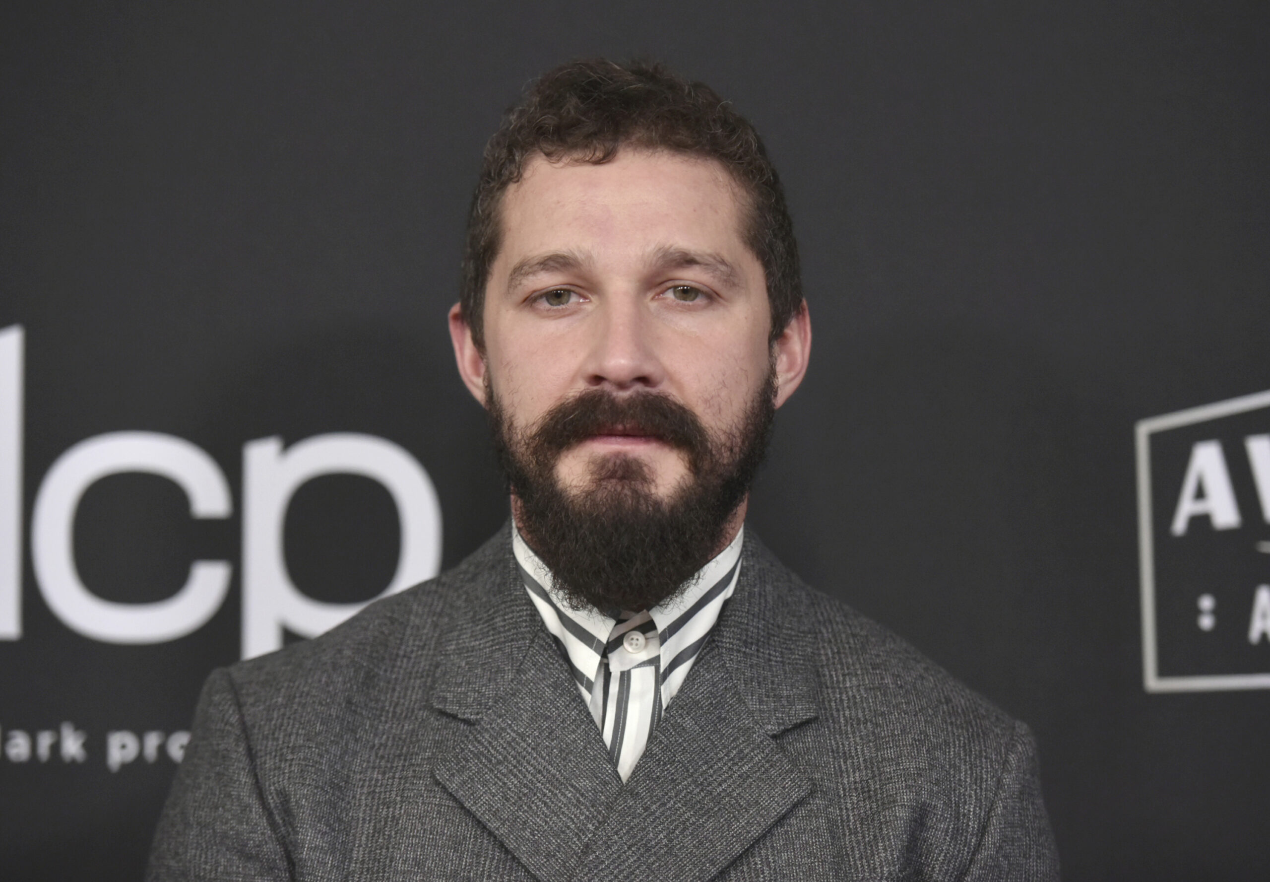 FILE - In this Nov. 3, 2019, file photo, Shia LaBeouf arrives at the 23rd annual Hollywood Film Awards at the Beverly Hilton Hotel in Beverly Hills, Calif. LaBeouf has been charged on Sept. 24, 2020, with misdemeanor battery and petty theft. Prosecutors allege that the 34-year-old actor fought with a man named Tyler Murphy and took his hat on June 12, according to a criminal complaint obtained by The Associated Press on Thursday, Oct. 1, from the Los Angeles city attorney. (Photo by Richard Shotwell/Invision/AP, File)