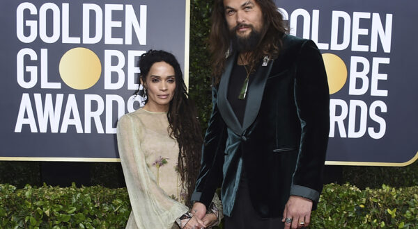 FILE - Lisa Bonet, left, and Jason Momoa arrive at the 77th annual Golden Globe Awards at the Beverly Hilton Hotel on Sunday, Jan. 5, 2020, in Beverly Hills, Calif. The couple  have ended their 16-year relationship. A joint statement posted on the “Aquaman” star’s Instagram page Wednesday, Jan. 12, 2022, said that Momoa and his wife were parting ways. (Photo by Jordan Strauss/Invision/AP, file)