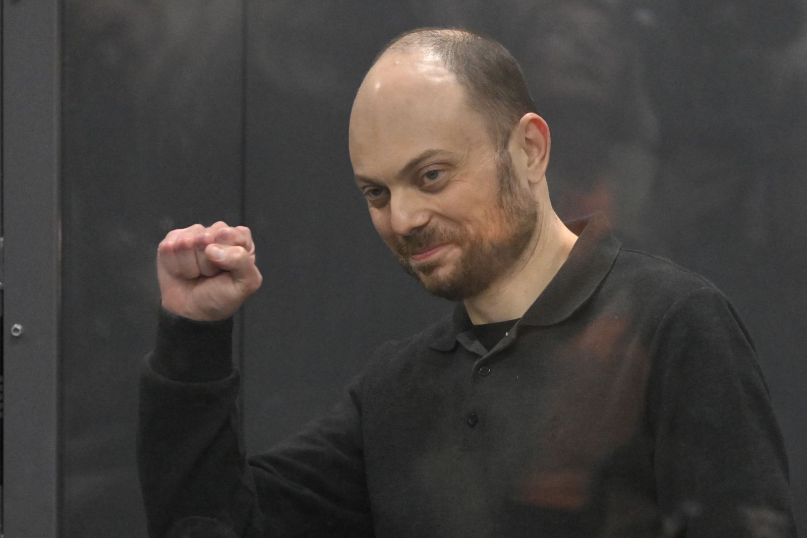 FILE - Russian opposition activist Vladimir Kara-Murza gestures standing in a glass cage in a courtroom during announcement of the verdict on appeal at the Moscow City Court in Moscow, Russia, on July 31, 2023. Most Russian opposition figures are either in prison at home or are in exile abroad. But they vow that they will still put up a fight against President Vladimir Putin as he seeks yet another term in office in an election scheduled for March.(AP Photo, File)