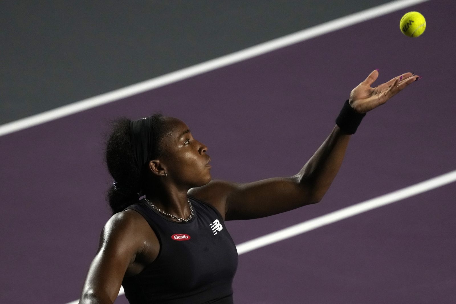 Coco Gauff of the United States serves to Jessica Pegula, of the United States, during a women's singles semifinal match at the WTA Finals tennis championships, in Cancun, Mexico, Saturday, Nov. 4, 2023. (AP Photo/Fernando Llano)