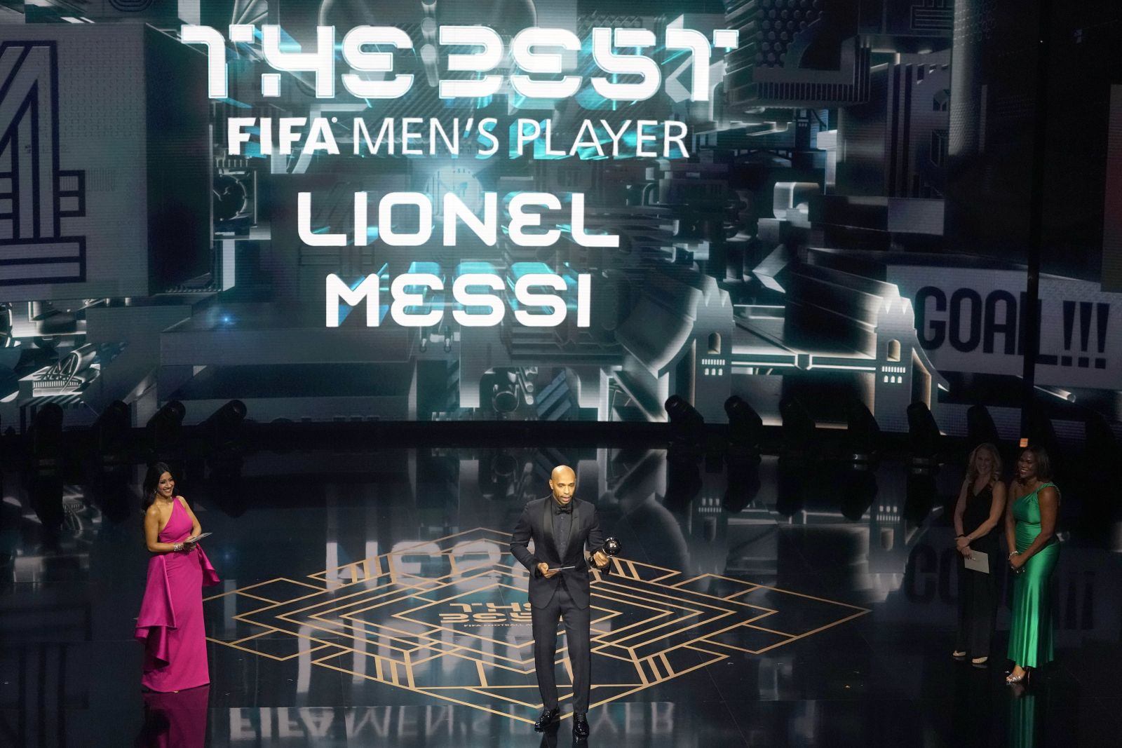 Former France soccer player Thierry Henry accepts on behalf of Argentina's Lionel Messi the Best Men's Player award during the FIFA Football Awards 2023 at the Eventim Apollo in Hammersmith, London, Monday, Jan. 15, 2024. (AP Photo/Kirsty Wigglesworth)