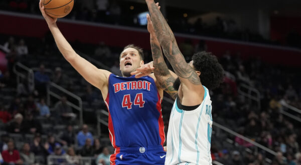 Detroit Pistons forward Bojan Bogdanovic (44) makes a layup as Charlotte Hornets center Nick Richards (4) defends during the second half of an NBA basketball game, Wednesday, Jan. 24, 2024, in Detroit. (AP Photo/Carlos Osorio)