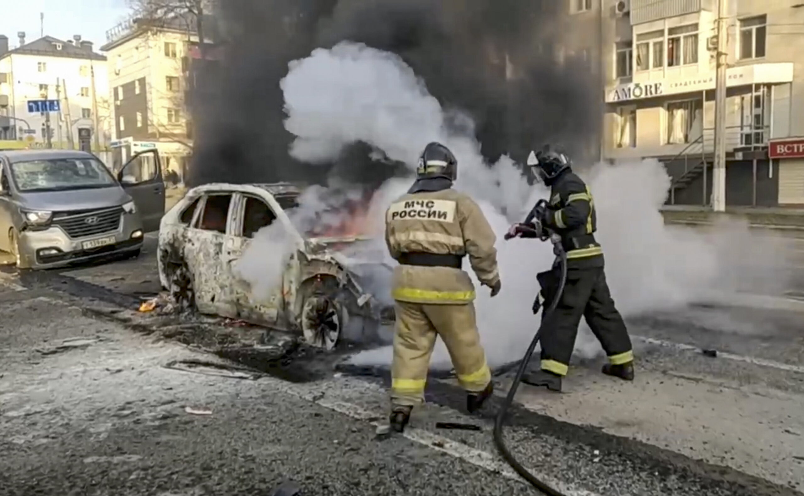 epa11049538 A handout photo made available by the Russian Emergency Ministry press service shows Russian firefighters extinguishing a burning car after shelling in Belgorod, Russia, 30 December 2023. 12 adults and two children were killed due to shelling by the Ukrainian Armed Forces, the press service of the Russian Ministry of Emergency Situations reported 30 December. On 24 February 2022, Russian troops entered Ukrainian territory in what the Russian president declared a 'Special Military Operation', starting an armed conflict that has provoked destruction and a humanitarian crisis.  EPA/RUSSIAN EMERGENCIES MINISTRY HANDOUT  HANDOUT EDITORIAL USE ONLY/NO SALES HANDOUT EDITORIAL USE ONLY/NO SALES