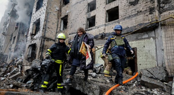 epa11053134 Rescuers evacuate a woman from the site of a damaged building after a missile strike in Kyiv (Kiev), Ukraine, 02 January 2024, amid the Russian invasion. In the early hours of 02 January, Russia launched missile attacks targeting Kyiv and Kharkiv, local officials reported. At least two women were killed, and nearly 70 others were injured in the two cities. In Kyiv, 27 people were hospitalized after a fire broke out in a multi-story building as a result of a rocket attack, the city mayor Vitali Klitschko wrote on telegram, adding that an injured elderly woman died in an ambulance. Some 130 residents were evacuated from the burning building, the State Emergency Service said.  EPA/SERGEY DOLZHENKO