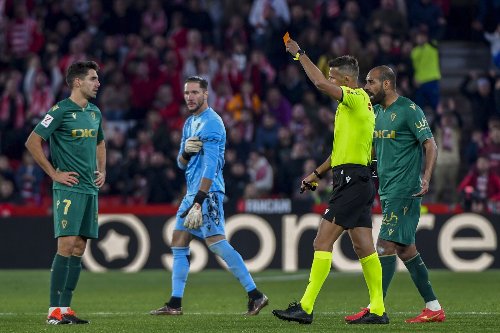 epa11055556 Cadiz's midfielder Ruben Sobrino (L) is ejected after being shown a red card by referee Juan Luis Pulido Santana during the LaLiga soccer match between Granada and Cadiz, Granada, southern Spain, 03 January 2024.  EPA/Miguel Angel Molina SOBRINO