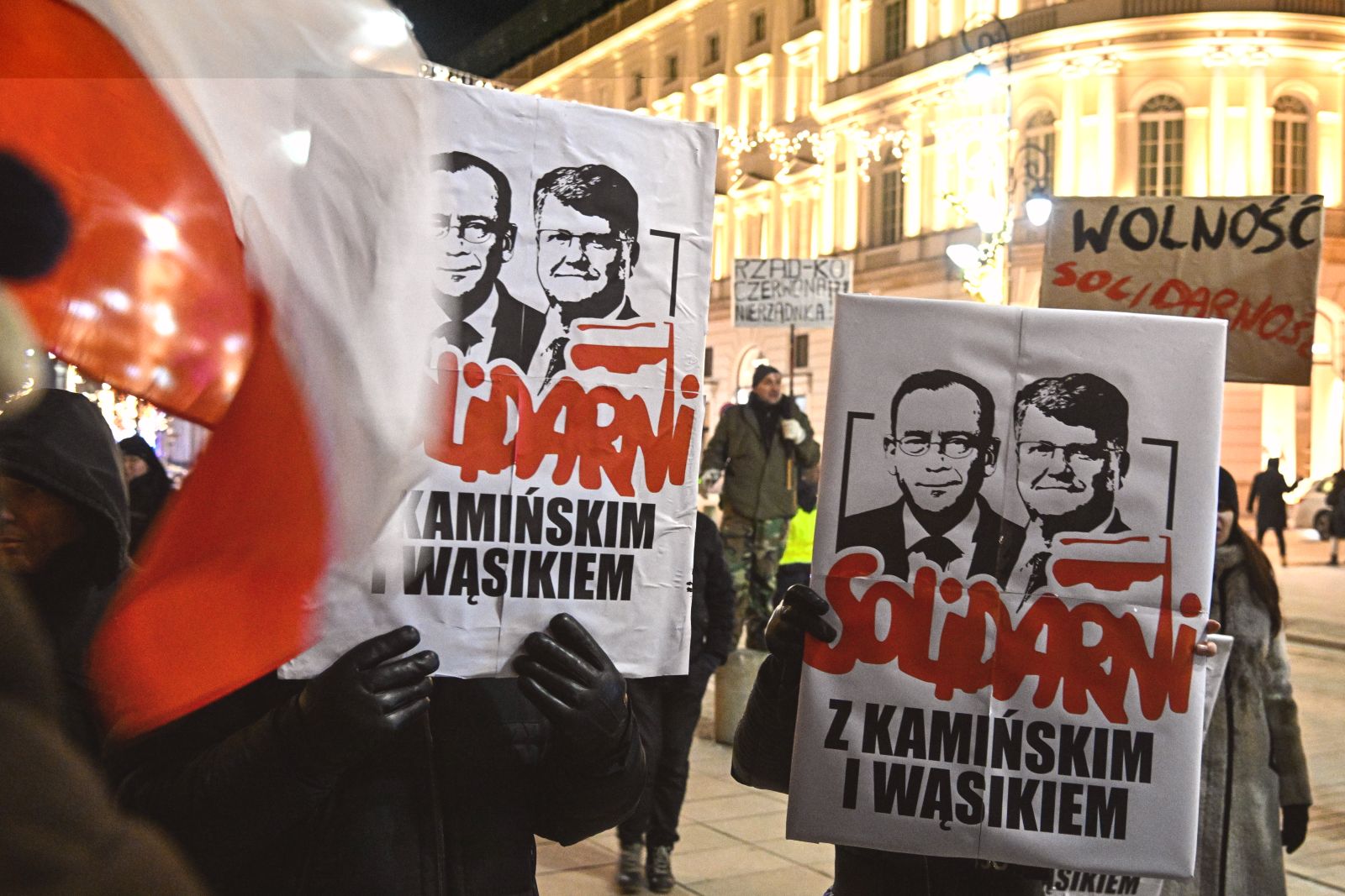epa11066597 Opposition supporters holds portraits of former Interior Minister Mariusz Kaminski and ex-deputy Interior Minister Maciej Wasik during a protest against the detention of two MPs from the Law and Justice party in front of the Presidential Palace in Warsaw, Poland, 09 January 2024. Opposition politicians have expressed their outrage over the detention of two MPs from the Law and Justice party who have been convicted of abuse of power. Mariusz Kaminski, a former interior minister, and Maciej Wasik, his ex-deputy, were detained by police officers at the Presidential Palace on 09 January evening. In December 2023, Kaminski and Wasik were sentenced to two years in prison for masterminding an anti-corruption provocation in 2007 when they were heading the Central Anti-Corruption Bureau (CBA). Earlier on 09 January, the police received documents containing an order issued by a Warsaw court to take both politicians into custody. 'In the Tusk-owned state, Civic Platform politicians charged with corruption are free, either in the Sejm, the lower house of parliament, or in the European Parliament,' Mariusz Blaszczak, the head of the Law and Justice (PiS) parliamentary caucus, wrote. ' And PiS politicians, who have been fighting against corruption during their entire political careers, are being sent to prison,' Blaszczak continued, adding that both politicians had been pardoned by the president and were still MPs.  EPA/Radek Pietruszka POLAND OUT