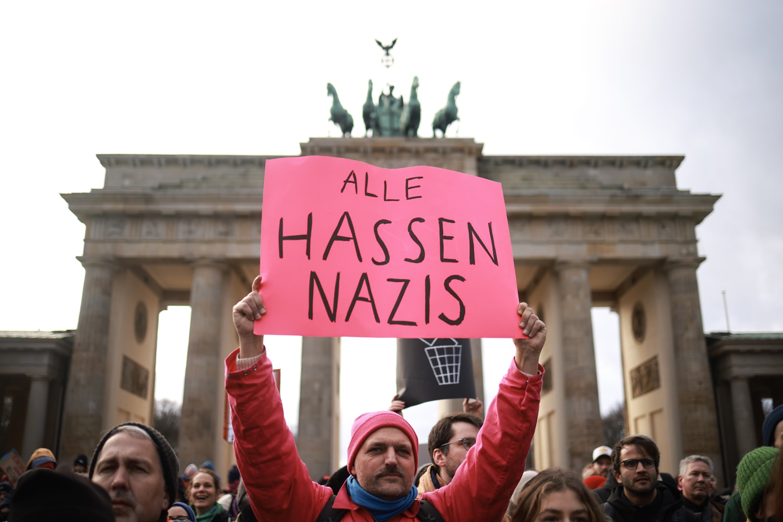 epa11076312 A protester holds a placard reading 'All hate Nazis' during a demonstration against the far-right Alternative for Germany (AfD) party in front of the Brandenburg Gate in Berlin, Germany, 14 January 2024. The protest held under the slogan 'Defend Democracy', was organized by the Fridays for Future movement, along with other non-governmental organizations, as a reaction to revelations of the investigative journalism group Correctiv, and their report about a meeting of far-right politicians, who allegedly discussed deportation plans referred to as 'remigration', a term promoting the forced return of 'migrants' to their place of origin.  EPA/CLEMENS BILAN