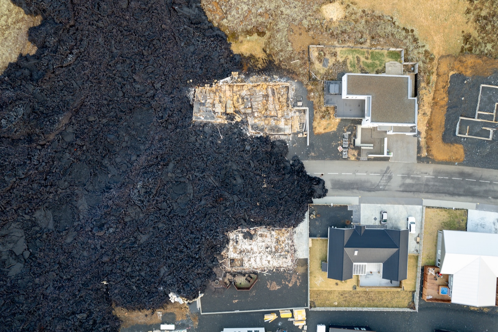 epa11079535 Image taken with a drone showing destroyed builings following lava explosions after a volcanic eruption near the town of Grindavik, in the Reykjanes peninsula, southwestern Iceland, 15 January 2024. A volcanic eruption began north of the town of Grindavik on the Reykjanes peninsula on 14 January, prompting authorities in Iceland to evacuate the small fishing town in the early morning as a precaution. The eruption is not expected to impact additional populated areas and does not present a 'threat to life', the Government of Iceland stated, adding that there are no disruptions to flights to and from Iceland. This is the second eruption in the area since December 2023, and the fifth since 2021.  EPA/ANTON BRINK