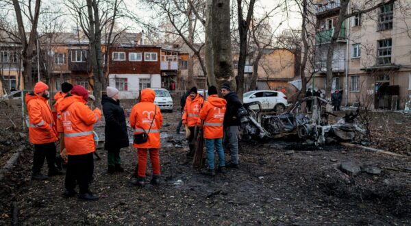 epa11084437 Communal workers inspect the site of a Russian drone attack in Odesa, Ukraine, 17 January 2024, amid the Russian invasion. At least three people were injured and 130 others evacuated from an apartment block after a Russian drone strike hit Odesa in an overnight attack, according to Oleg Kiper, Odesa's head of military administration.  EPA/Ihor Hora