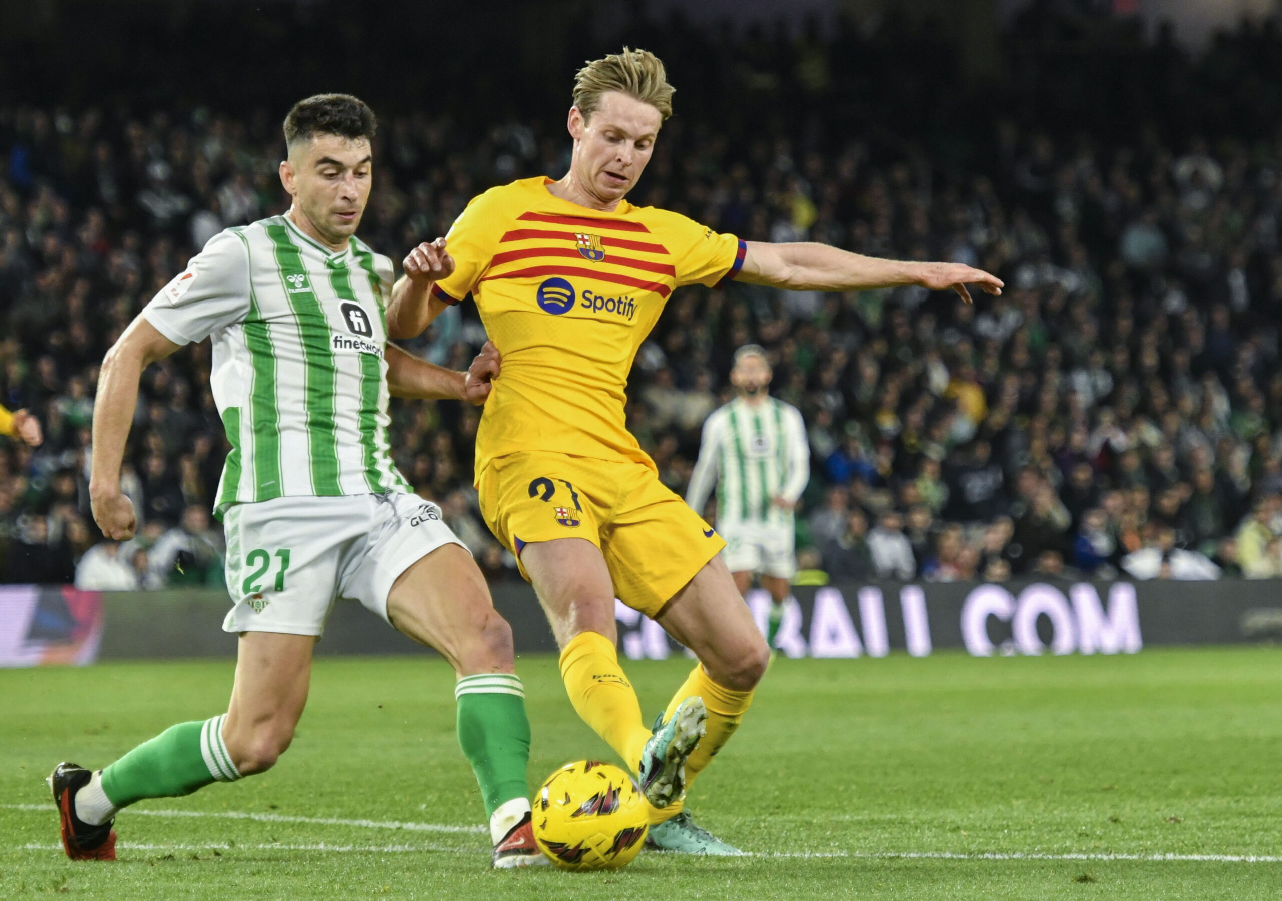 epa11094823 Betis' midfielder Marc Roca (L) duels for the ball with Barcelona's midfielder Frenkie De Jong (R) during the Spanish LaLiga soccer match between Real Betis and FC Barcelona in Seville, Spain, 21 January 2024.  EPA/Raul Caro