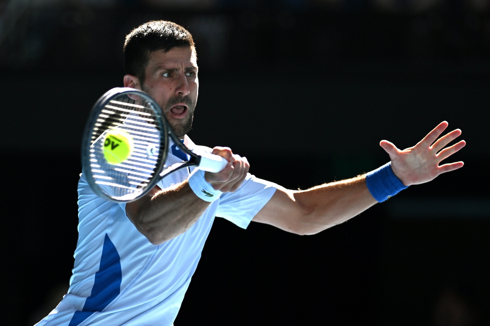 epa11097630 Novak Djokovic of Serbia plays a return shot during his quarter final match against Taylor Fritz of the USA on Day 10 of the 2024 Australian Open at Melbourne Park in Melbourne, Australia, 23 January 2024.  EPA/LUKAS COCH  AUSTRALIA AND NEW ZEALAND OUT