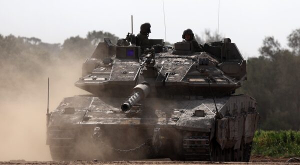 epa11098886 Israeli soldiers on a Merkava tank patrol along the southern part of the border with the Gaza Strip near Khan Yunis, as seen from an undisclosed location in Israel, 23 January 2024. More than 25,400 Palestinians and at least 1,330 Israelis have been killed, according to the Palestinian Health Ministry and the Israel Defense Forces (IDF), since Hamas militants launched an attack against Israel from the Gaza Strip on 07 October 2023, and the Israeli operations in Gaza and the West Bank which followed it.  EPA/ATEF SAFADI