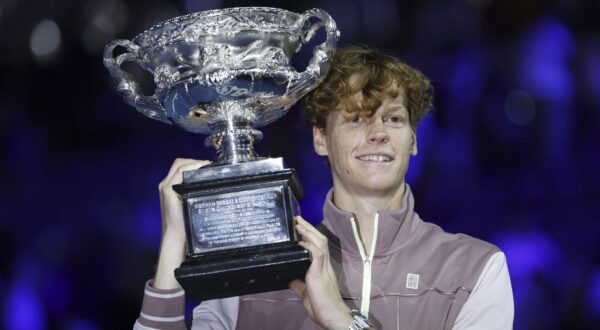epa11110477 Jannik Sinner of Italy celebrates with the Norman Brookes Challenge Cup trophy after winning the Men's Singles final match against Daniil Medvedev of Russia at the 2024 Australian Open tennis tournament, in Melbourne, Australia, 28 January 2024.  EPA/MAST IRHAM
