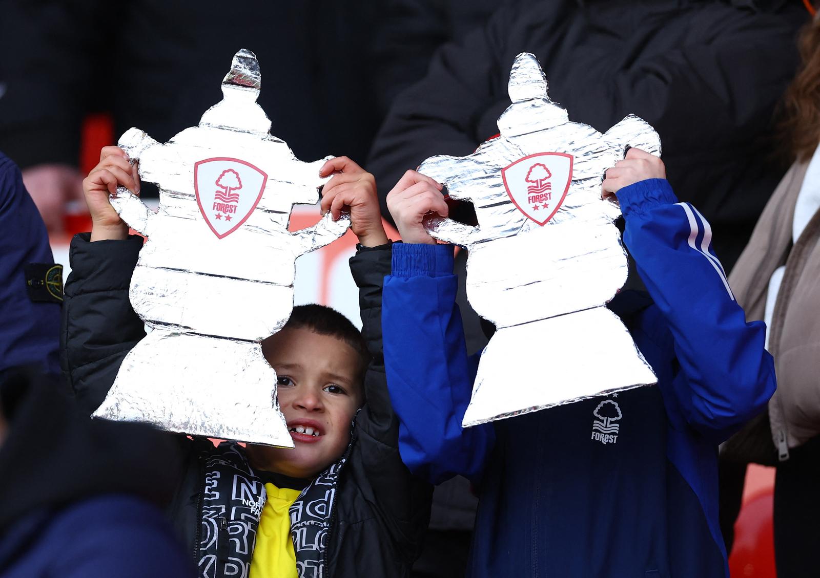 Soccer Football -  FA Cup - Third Round - Nottingham Forest v Blackpool - The City Ground, Nottingham, Britain - January 7, 2024 Nottingham Forest fans holding a cut out of the FA Cup trophy inside the stadium before the match REUTERS/Molly Darlington Photo: MOLLY DARLINGTON/REUTERS