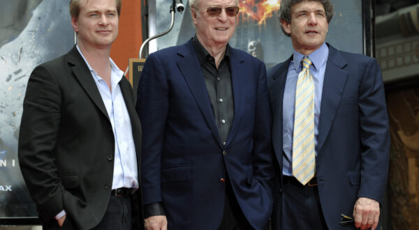 Sir Michael Caine, center, poses with director Christopher Nolan, left, and Warner Bros. Entertainment President and COO Alan Horn after getting his hands and feet in cement during a ceremony at Grauman's Chinese Theatre in Los Angeles, Friday, July 11, 2008. (AP Photo/Chris Pizzello)