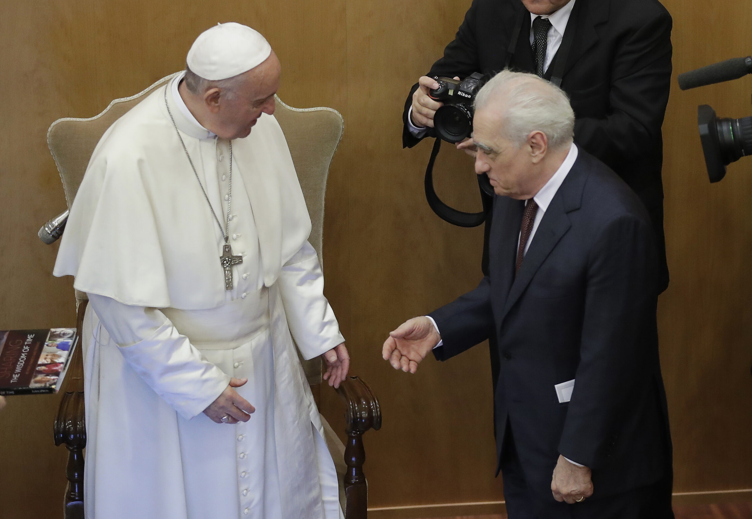 Film director Martin Scorsese greets Pope Francis at the end of the book presentation "The Wisdom of Time", a collection of 250 interviews from over 30 countries, with various stories of old and young people commented by Pope Francis. (AP Photo/Alessandra Tarantino)