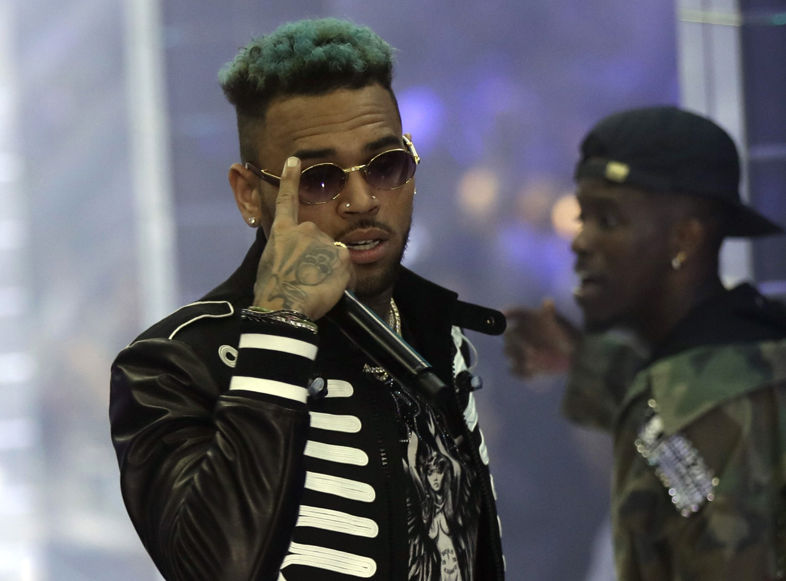 FILE - In this Sept.21, 2018 file photo, singer Chris Brown performs during Philipp Plein's women's 2019 Spring-Summer collection, unveiled during the Fashion Week in Milan, Italy. Two police officials say U.S. singer Chris Brown and two other people are in custody in Paris after a woman filed a rape complaint. (AP Photo/Luca Bruno, File)