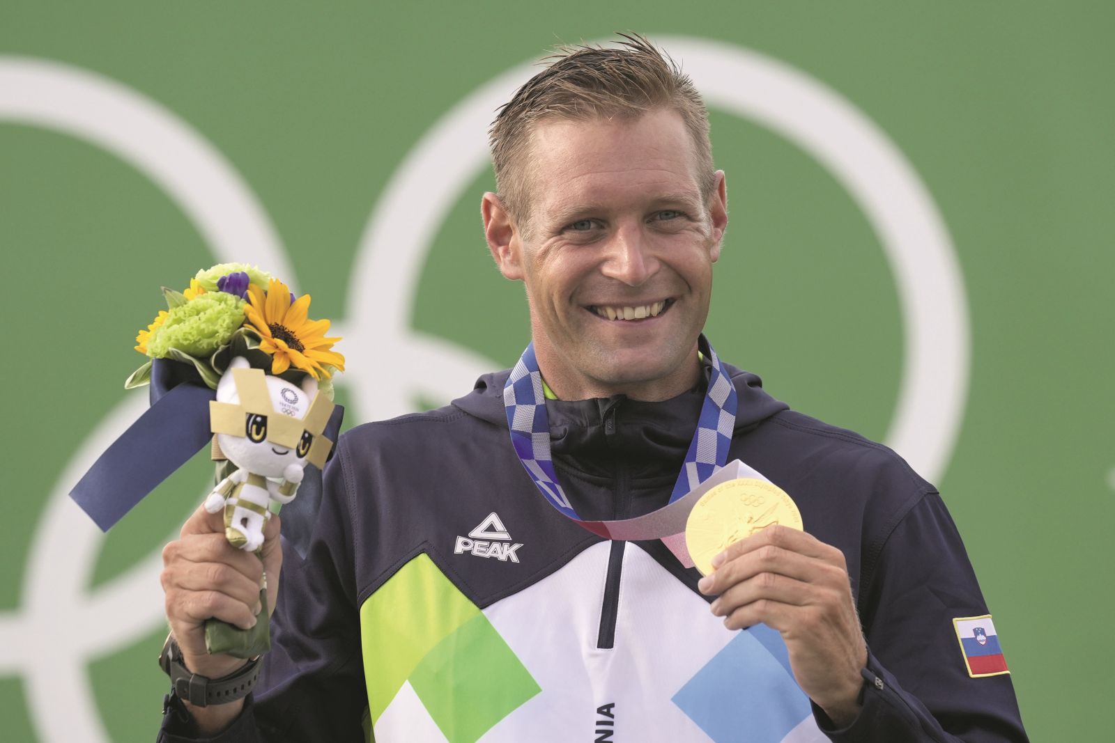 Benjamin Savsek of Slovenia poses with his medal after winning gold in the Men's C1 Canoe Slalom at the 2020 Summer Olympics, Monday, July 26, 2021, in Tokyo, Japan. (AP Photo/Kirsty Wigglesworth)
