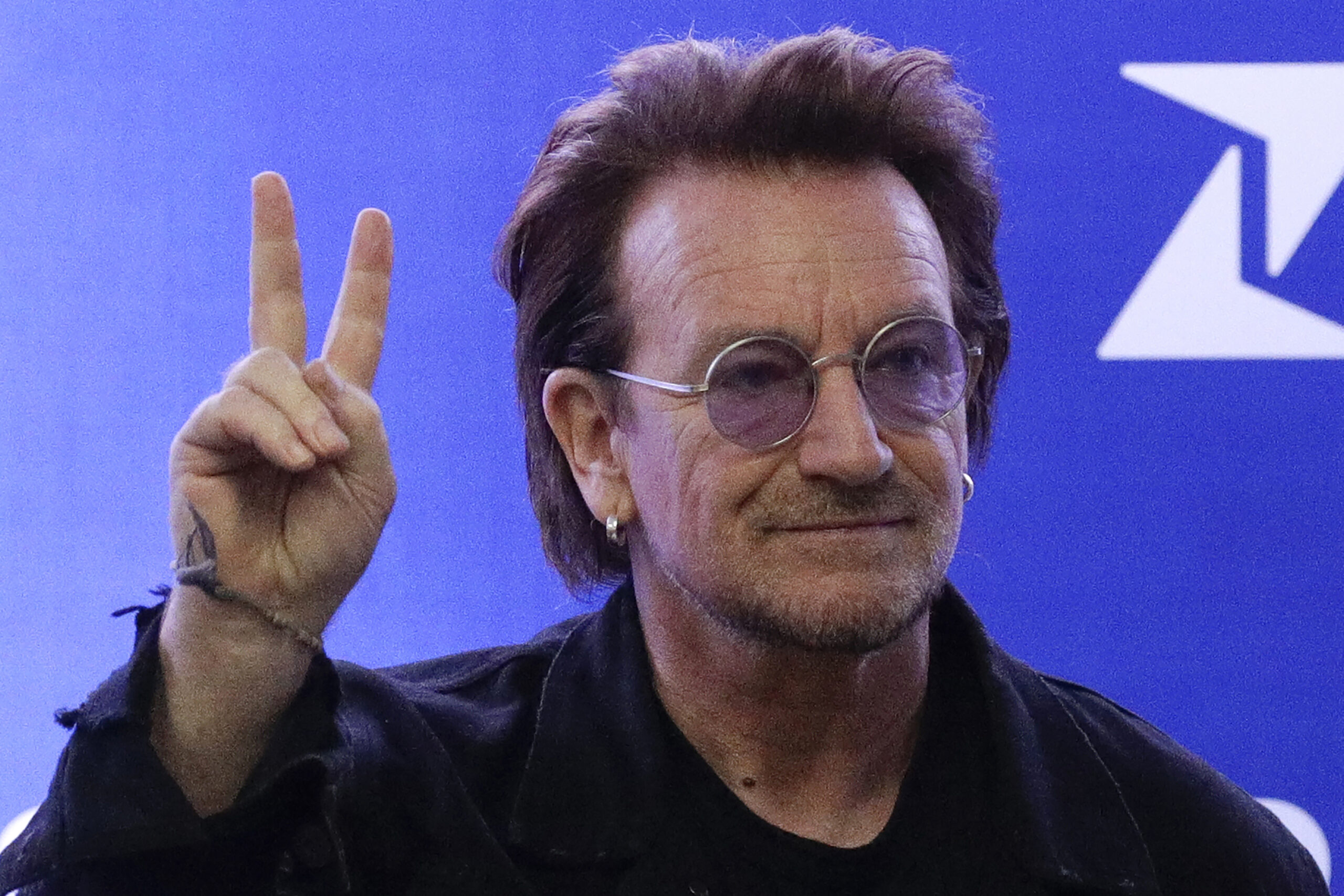 FILE - U2 singer Bono gestures as he attends the launching of the first blood by drone delivery service in the country at the Philippine Red Cross headquarters in suburban Mandaluyong, east of Manila, Philippines on Tuesday Dec. 10, 2019. Bono opened his book tour for his bestselling "Surrender: 40 Songs, One Story," on Wednesday, Nov. 2, 2022, to thousands of screaming fans at Manhattan's Beacon Theatre. (AP Photo/Aaron Favila, File)