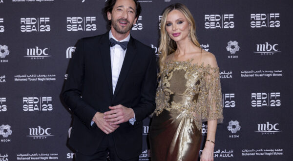 Adrien Brody and Georgina Chapman pose for photographers upon arrival for the closing ceremony red carpet during The Red Sea International Film Festival in Jeddah, Saudi Arabia, Thursday, Dec. 7, 2023. (Photo by Joel C Ryan/Invision/AP)