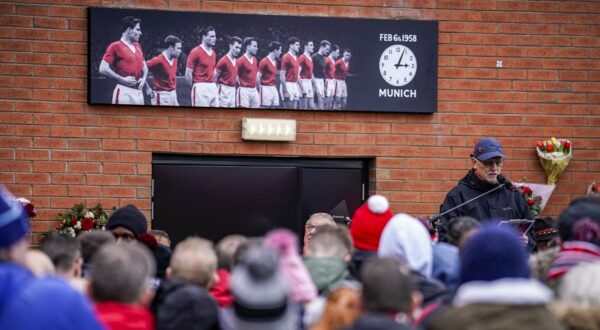 People gather outside the stadium during a commemoration of the Feb. 6,1958, Munich air disaster before the English Premier League soccer match between Manchester United and West Ham at the Old Trafford in Manchester, England, Sunday, Feb. 4, 2024. On board the crashed plane was the Manchester United football team, nicknamed the Busby Babes, along with supporters and journalists. Twenty-three of the 44 passengers on board the aircraft died in the crash. (AP Photo/Dave Thompson)
