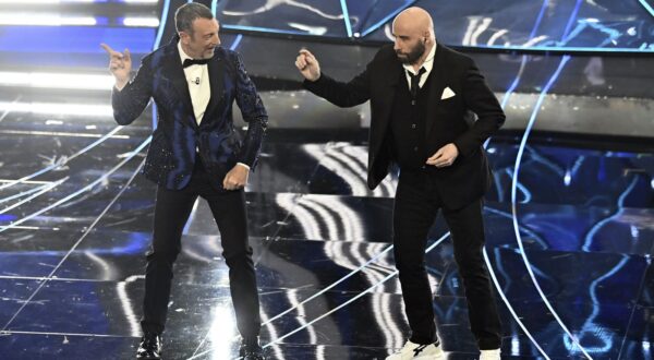 John Travolta, right, and Amadeus perform during the 74th edition of the Sanremo Italian Song Festival at the Ariston Theatre in Sanremo, northern Italy, Tuesday, Feb. 7, 2024. Entertainment. (Marco Alpozzi/LaPresse via AP)
