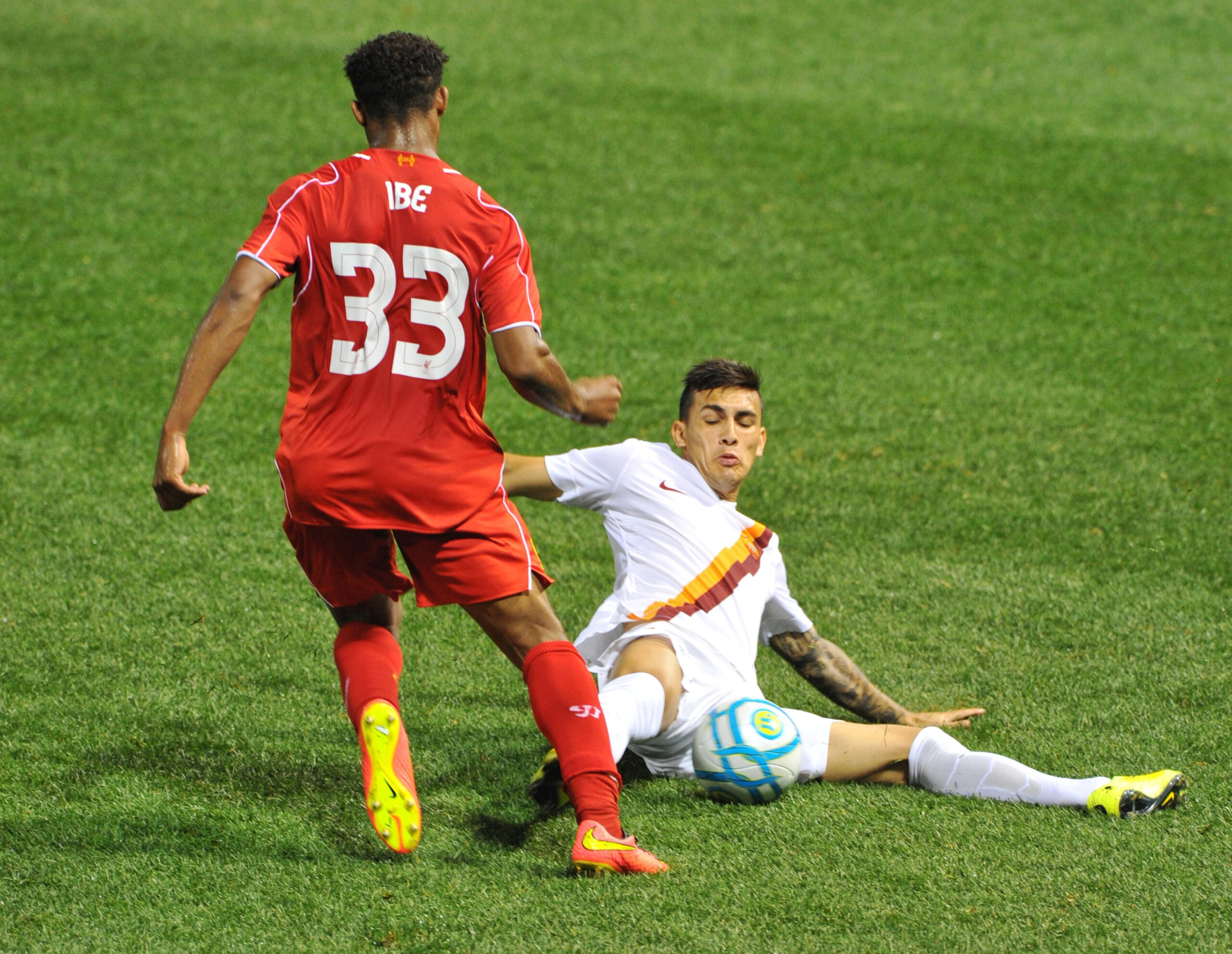 23 July 2014:Roma defender Tin Jedvaj #33 slides in and knocks the ball away from Liverpool forward Jordon Ibe #33 during the Roma game against Liverpool at Fenway Park in Boston, MA.  (Icon Sportswire via AP Images)