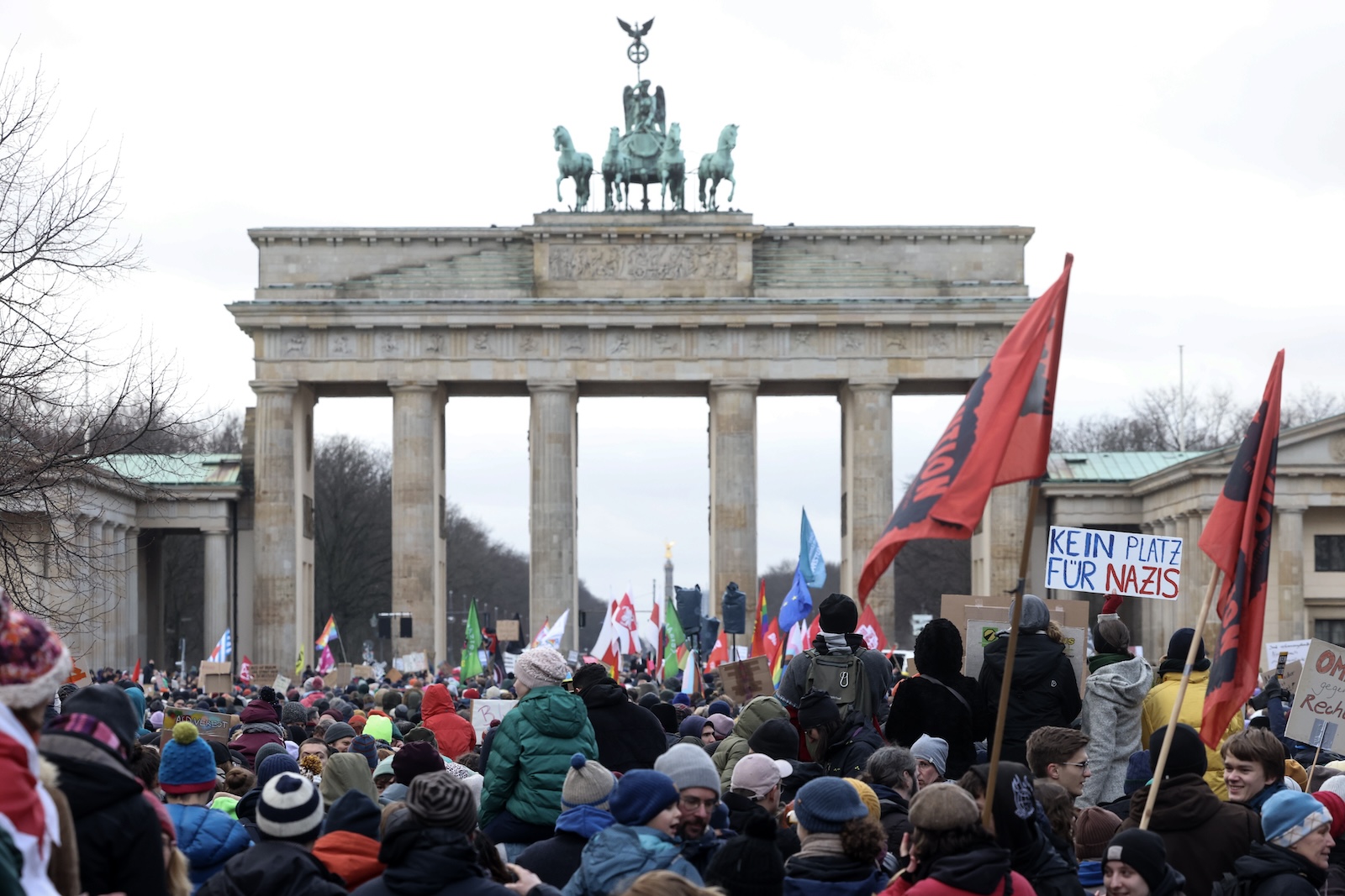 epa11076295 A protester holds a placard reading 'No place for Nazis' during a demonstration against the far-right Alternative for Germany (AfD) party in front of the Brandenburg Gate in Berlin, Germany, 14 January 2024. The protest held under the slogan 'Defend Democracy', was organized by the Fridays for Future movement, along with other non-governmental organizations, as a reaction to revelations of the investigative journalism group Correctiv, and their report about a meeting of far-right politicians, who allegedly discussed deportation plans referred to as 'remigration', a term promoting the forced return of 'migrants' to their place of origin.  EPA/CLEMENS BILAN