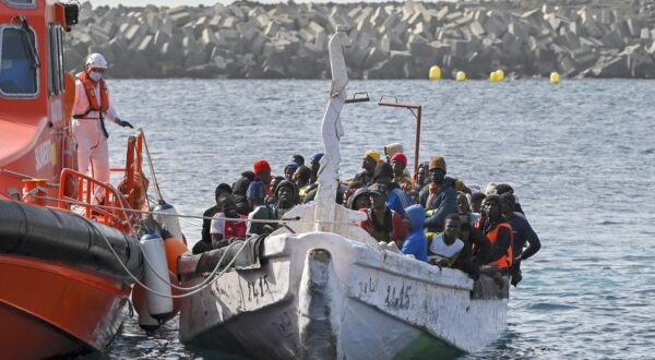 epa11112786 Migrants react upon arrival to La Restinga's port, in El Hiero, Canary islands, Spain, 29 January 2024. 108 migrants were rescued by Spanish 'Salvamento Maritimo' Maritime Safety and Rescue Society as they sailed aboard a dugout nearby. A total of 255 migrants, among which were five children, have been rescued within the last few hours in three different dugouts.  EPA/GELMERT FINOL