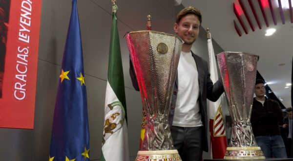 epa11114201 Croatian midfielder Ivan Rakitic poses next to Europa League trophies during his farewell press conference in Seville, Spain, 30 January 2024. Rakitic leaves Sevilla FC after 323 official soccer matches over to terms, 2011 to 2014 and 2020 to 2024, to join Saudi Pro League club Al-Shabab.  EPA/David Arjona