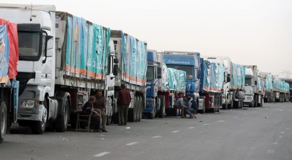 epa11149423 A convoy of trucks carrying humanitarian aid supplies for Gaza waits on the main Ismailia desert road, about 300km east of the Egyptian border with Gaza, on its way to the Rafah crossing, Egypt, 13 February 2024. More than 28,300 Palestinians and over 1,300 Israelis have been killed, according to the Palestinian Health Ministry and the Israel Defense Forces (IDF), since Hamas militants launched an attack against Israel from the Gaza Strip on 07 October 2023, and the Israeli operations in Gaza and the West Bank which followed it.  EPA/KHALED ELFIQI